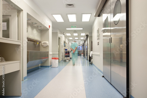 Photo: Doctor walking through hospital corridor Doctor walking through hospital corridor