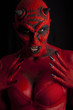Sexy red devil, black background.