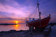 The famous red boat of Mykonos at sunset. Greece.