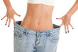 Funny woman shows her weight loss by wearing an old jeans Funny woman shows her weight loss by wearing an old jeans