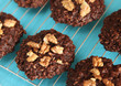 Chocolate walnuts oatmeal cookies on cooling rack food photo