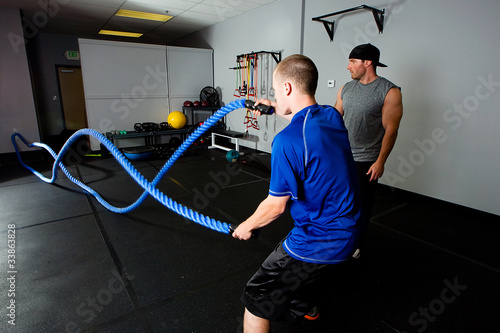 Photo: Workout with a rope in a gym with a trainer Workout with a rope in a gym with a trainer