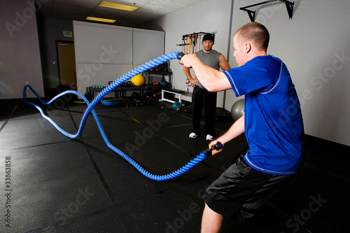 Photo: Workout with a rope in a gym with a trainer Workout with a rope in a gym with a trainer