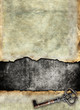Grunge torn surface with antique key, vintage background