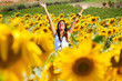 Happy girl between sunflowers Happy girl between sunflowers