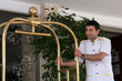 Photo: Bellboy with luggage cart. Bellboy with luggage cart.
