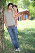 Young couple standing outside a wooden cabin