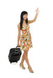 woman with luggage waving