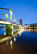 Wide angle view on green bridge reflecting in the river