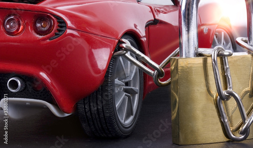 Photo: Car chained with padlock close up Car chained with padlock close up