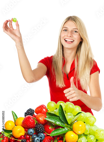 Photo: young smiling woman with fresh berries young smiling woman with fresh berries