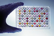a hand with a microplate a hand with a microplate