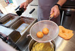 Chef cooking dim sum in a deep fryer Chef cooking dim sum in a deep fryer