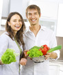 Young happy couple cooking together at home kitchen. Diet Young happy couple cooking together at home kitchen. Diet