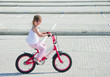 A little girl riding her bicycle