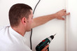 Workman using drill