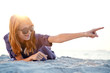 Beautiful redhead girl with headphones at beach sand.