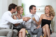 Two couples celebrating with champagne