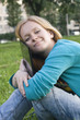 pretty woman with laptop on the green grass