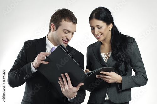 Photo: businessman and businesswoman looking at portfolio businessman and businesswoman looking at portfolio