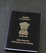 Indian passport on black wooden table top