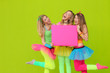 happy party or fancy dress girls with blank board