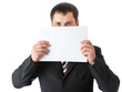 A businessman is holding a blank sheet of paper A businessman is holding a blank sheet of paper