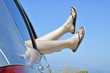 Woman with feet in the way the car window