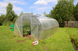 plastic hothouse in summer garden