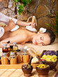 Woman getting thai herbal compress massage . Woman getting thai herbal compress massage .
