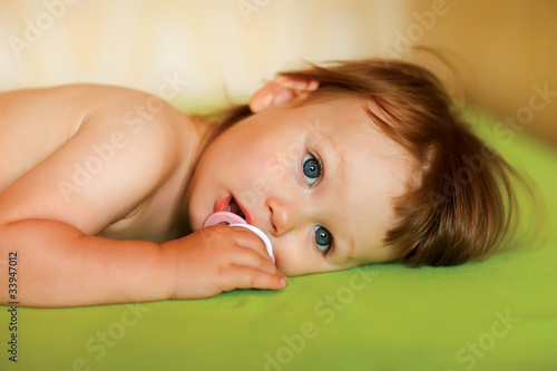 Photo: Cute baby girl with a soother in her mouth Cute baby girl with a soother in her mouth