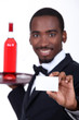 Wine waiter holding forth a business card