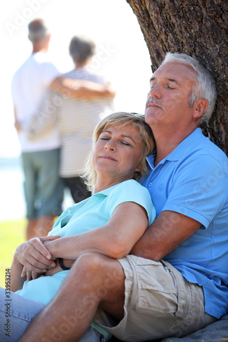 Photo: Mature couple dozing in the sunshine Mature couple dozing in the sunshine