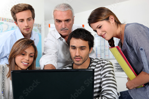 Photo: group of people watching a screen group of people watching a screen