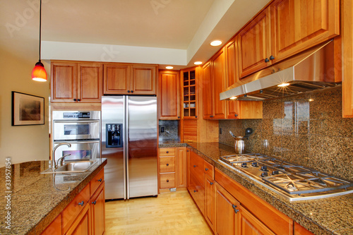Photo: Beautiful kitchen with island, granite and hardwood floor Beautiful kitchen with island, granite and hardwood floor