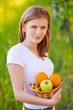 portrait of woman holding basket with fruits