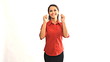 Young latina businesswoman with thumbs up and turning