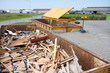 Big iron dumpster with groundwood  at a refuse dump