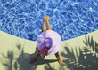 Photo: young woman in pink bikini relaxing poolside young woman in pink bikini relaxing poolside