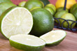 Sliced and whole Limes closeup background