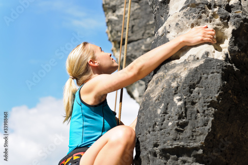 Photo: Rock climbing blond woman on rope sunny Rock climbing blond woman on rope sunny