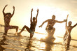 young people dancing and spraying at the beach