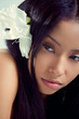 Beautiful young woman with a tropical flower in her hair Beautiful young woman with a tropical flower in her hair