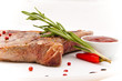Closeup of grilled steak with peper corns and rosemary
