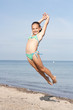 Mädchen springt am Strand