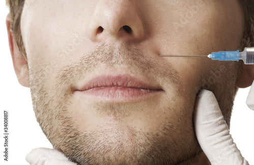 Foto: Man gets cosmetic injection of botox. Beauty Treatment Man gets cosmetic injection of botox. Beauty Treatment