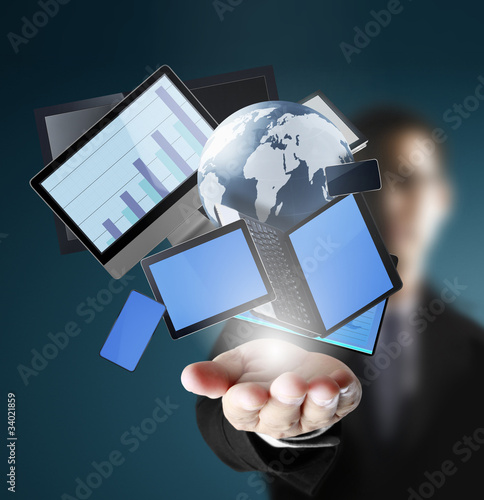 Photo: Mobile phones and laptops in hand Mobile phones and laptops in hand