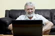 Elderly man in front of a laptop Elderly man in front of a laptop