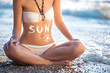 Woman belly with creme drawn sun