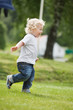 Photo: Boy running in garden Boy running in garden